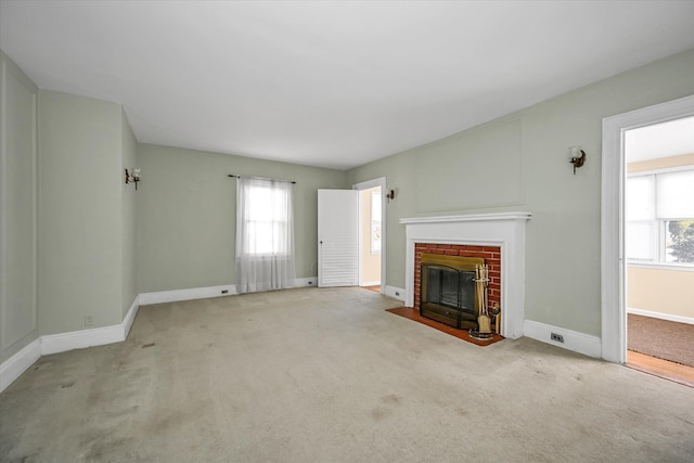 unfurnished living room with a fireplace and light carpet