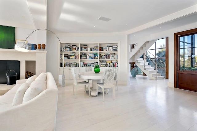 dining room with built in features and light hardwood / wood-style floors