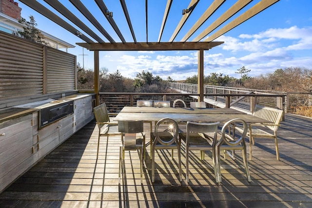 wooden terrace featuring a pergola, an outdoor kitchen, and a bar