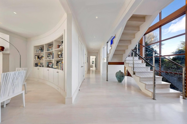 corridor with plenty of natural light and built in shelves