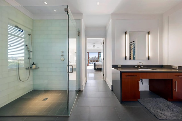 bathroom featuring a shower with door, tile patterned floors, vanity, and crown molding