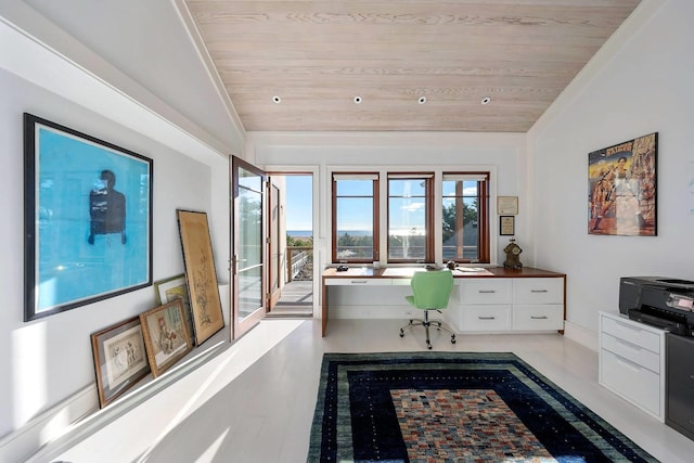 interior space with vaulted ceiling, wooden ceiling, and built in desk