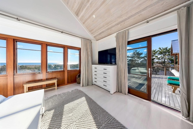 bedroom featuring a water view, access to exterior, wood ceiling, and wooden walls