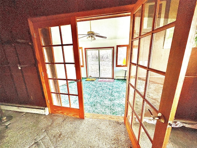 interior space with a baseboard heating unit, ceiling fan, and french doors