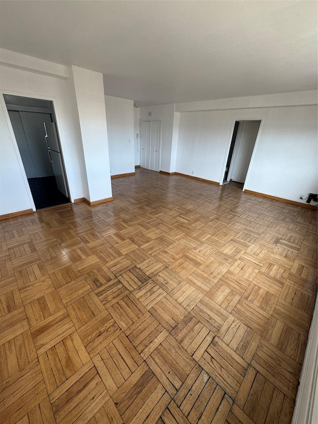 unfurnished room featuring light parquet flooring