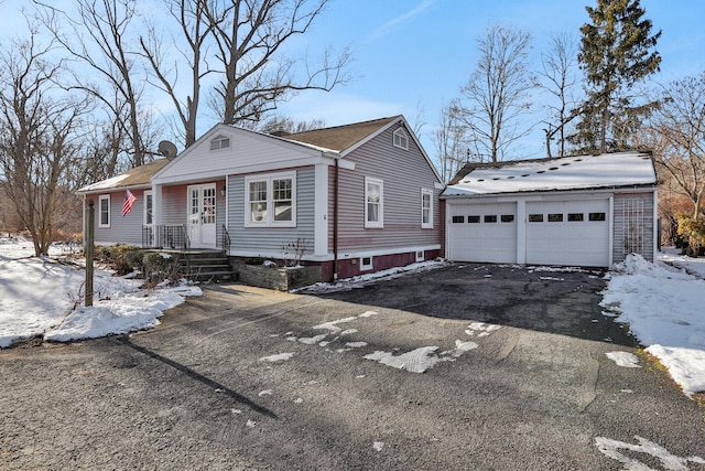 view of front of house with a garage and an outdoor structure