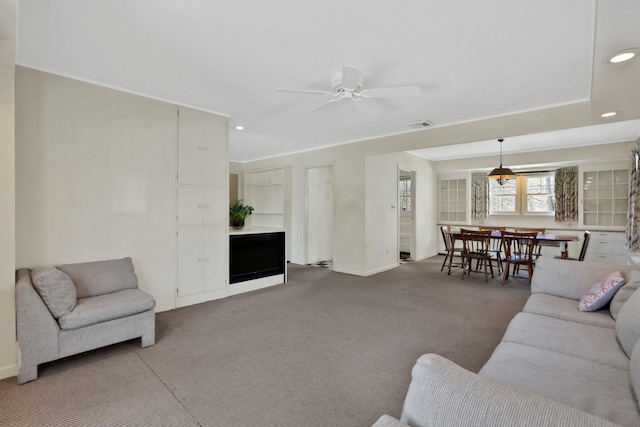 living room with ceiling fan and carpet flooring