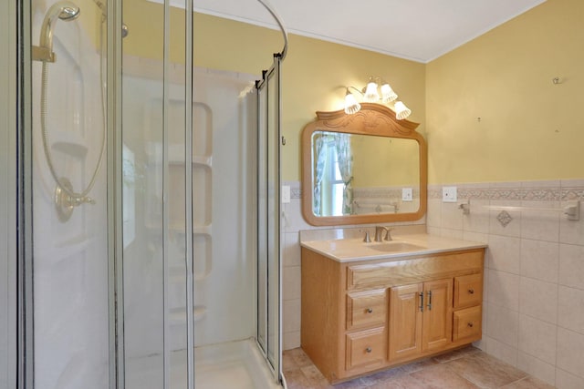 bathroom featuring vanity, a shower with shower door, tile patterned flooring, and tile walls