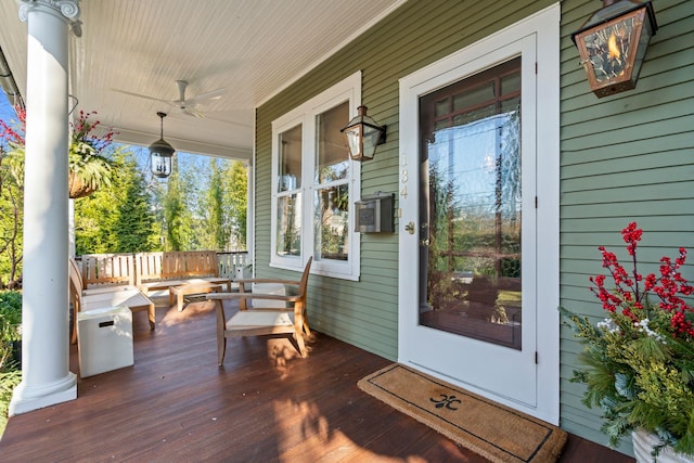 wooden deck featuring ceiling fan and covered porch