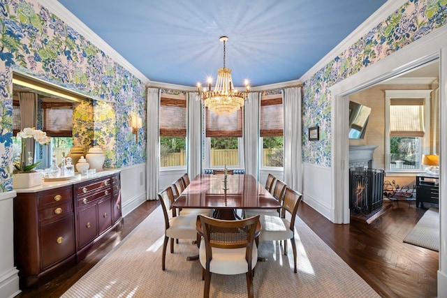 dining area featuring dark parquet floors, a notable chandelier, and ornamental molding