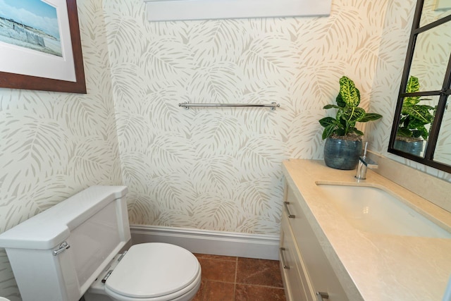 bathroom with toilet, tile patterned flooring, and vanity