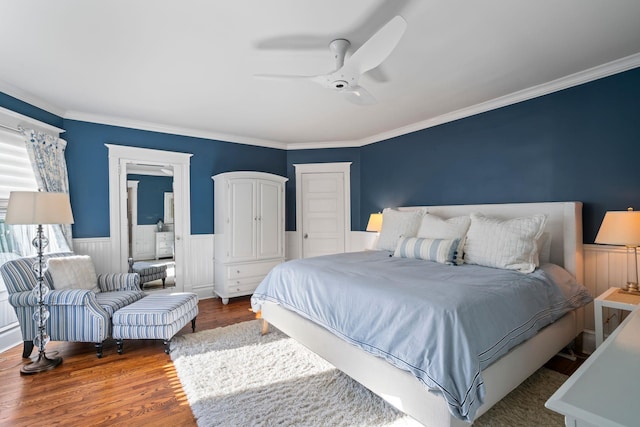 bedroom featuring ceiling fan, ornamental molding, and hardwood / wood-style flooring