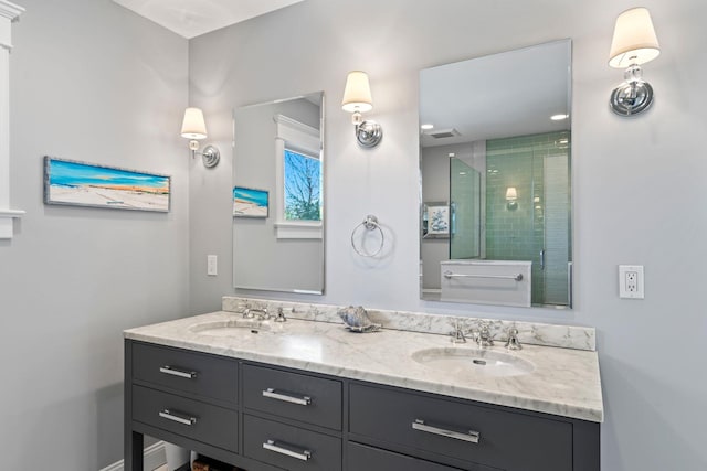 bathroom with vanity and a shower with door