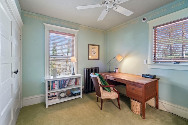 carpeted office featuring ceiling fan, radiator, and plenty of natural light