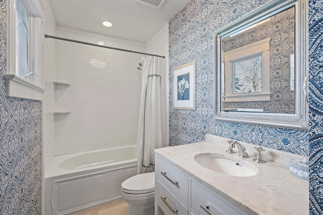 full bathroom featuring toilet, vanity, and shower / tub combo with curtain