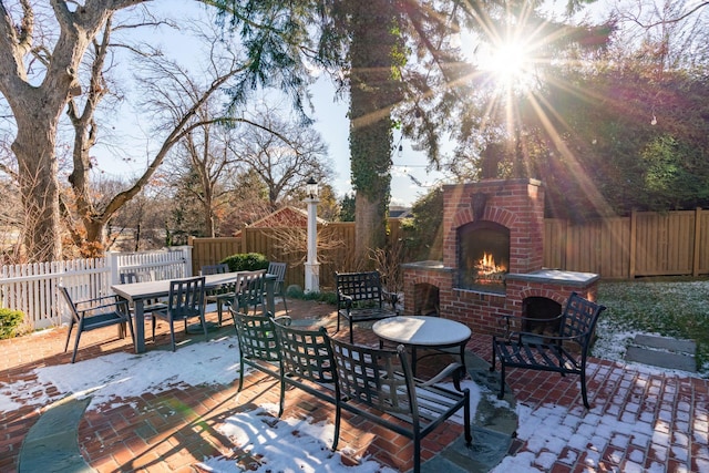 view of patio / terrace featuring an outdoor brick fireplace