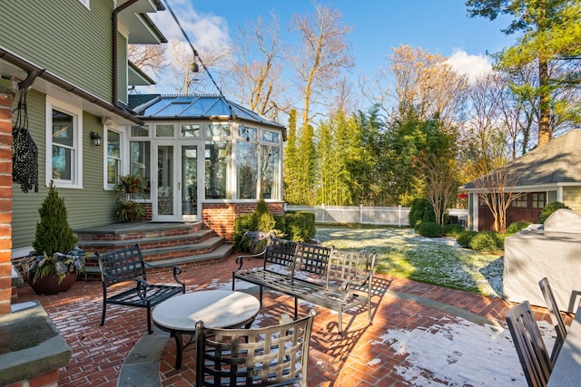 view of patio with a sunroom