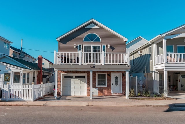 view of front facade featuring a garage and a balcony