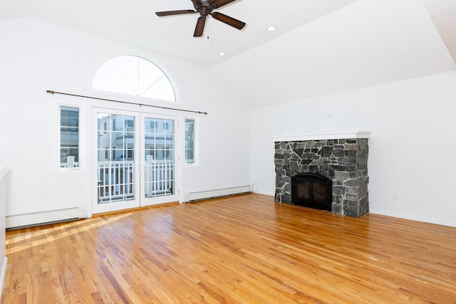 unfurnished living room featuring light hardwood / wood-style floors, a baseboard radiator, ceiling fan, and a fireplace