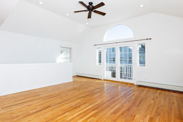 interior space featuring a baseboard heating unit, ceiling fan, lofted ceiling, and light wood-type flooring