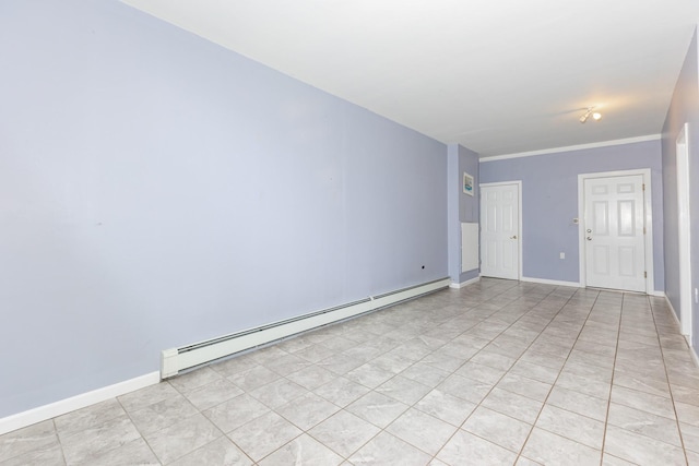 spare room featuring a baseboard heating unit and light tile patterned flooring