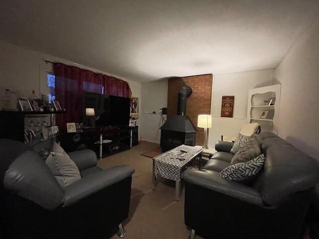 living room featuring light carpet and a wood stove