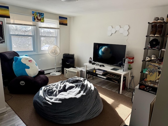 living room featuring a baseboard radiator and hardwood / wood-style floors