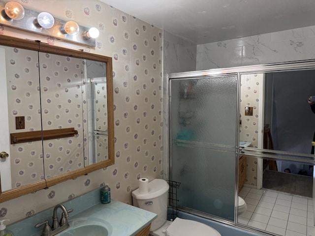 full bathroom with tile patterned floors, shower / bath combination with glass door, vanity, and toilet