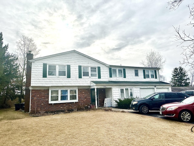 view of front property featuring a garage and a front lawn