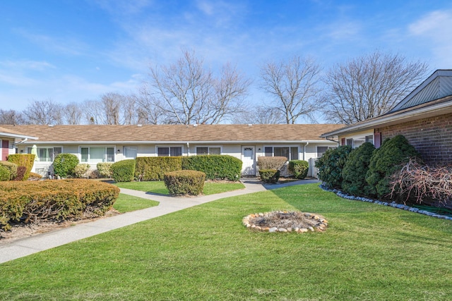 ranch-style house with a front yard and brick siding