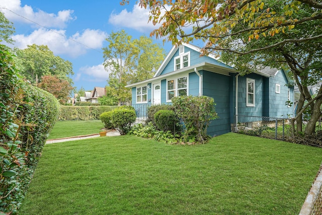 view of side of property with a lawn