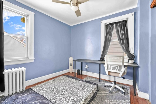 interior space featuring crown molding, radiator heating unit, a closet, and ceiling fan