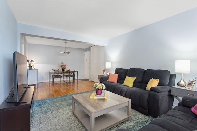 living room featuring an inviting chandelier and hardwood / wood-style floors