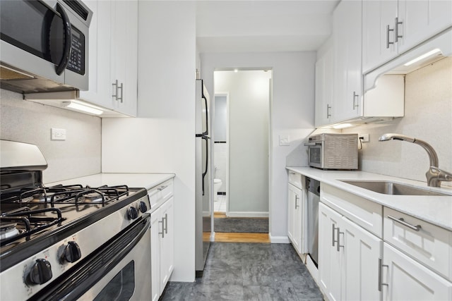 kitchen with white cabinetry, sink, and stainless steel appliances