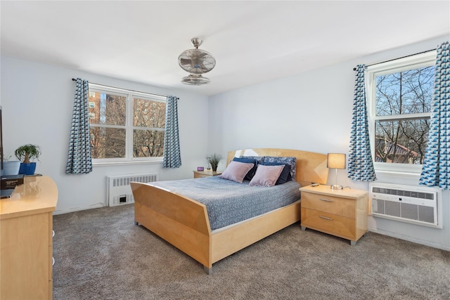 carpeted bedroom featuring multiple windows, radiator heating unit, and a wall unit AC