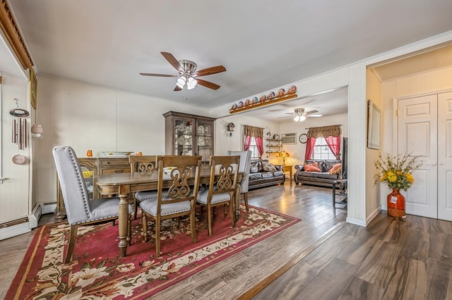 dining room with ceiling fan, an AC wall unit, and dark hardwood / wood-style floors