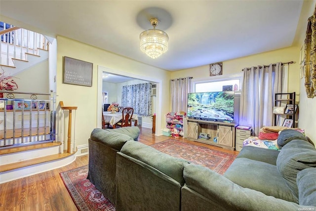 living room with an inviting chandelier and wood-type flooring