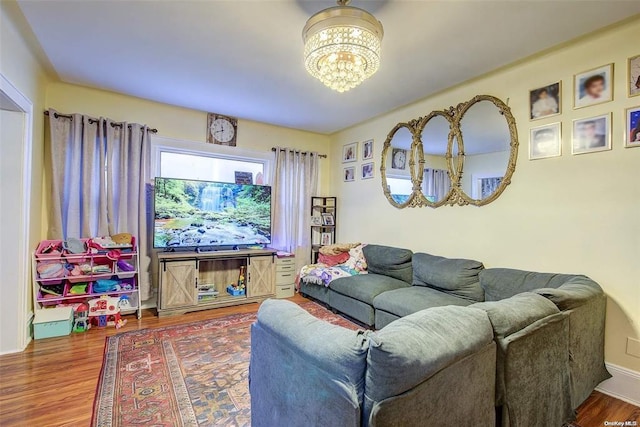 living room with a notable chandelier and wood-type flooring