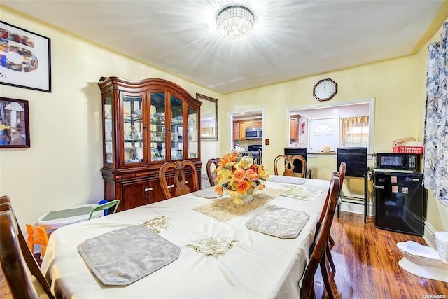 dining room featuring a notable chandelier and dark wood-type flooring