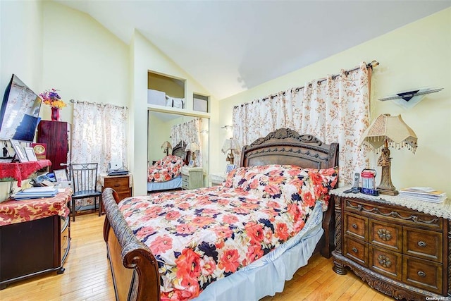 bedroom with light hardwood / wood-style flooring and vaulted ceiling