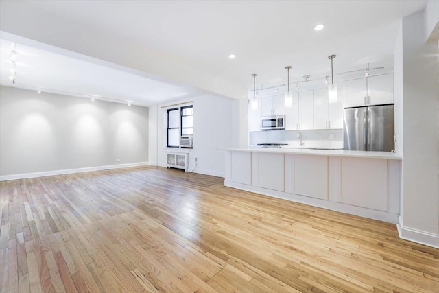 interior space with cooling unit and light wood-type flooring