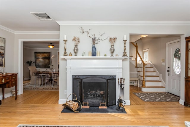 living room with hardwood / wood-style floors and ornamental molding