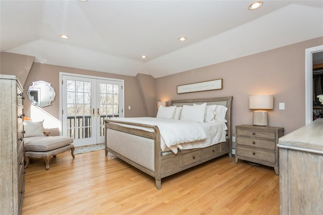 bedroom featuring french doors, lofted ceiling, access to outside, and light hardwood / wood-style flooring