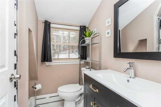 bathroom featuring vanity, baseboard heating, and toilet