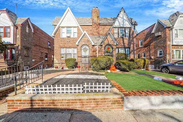 tudor-style house with a front lawn