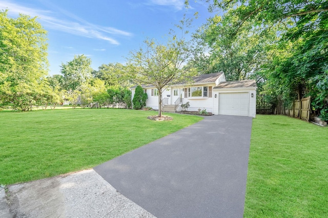 ranch-style house featuring a front yard and a garage