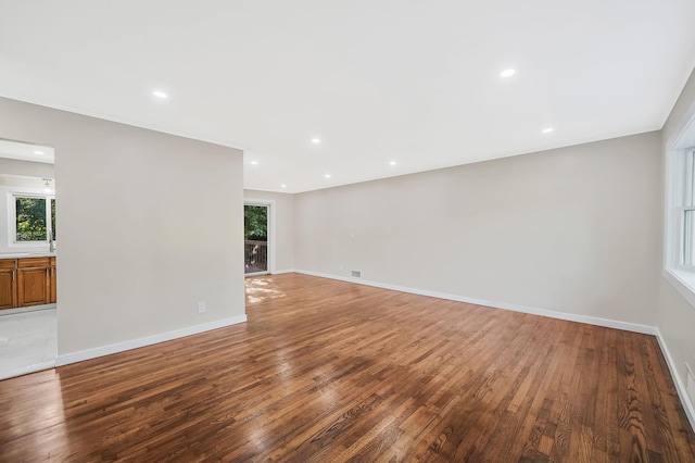 empty room with hardwood / wood-style floors