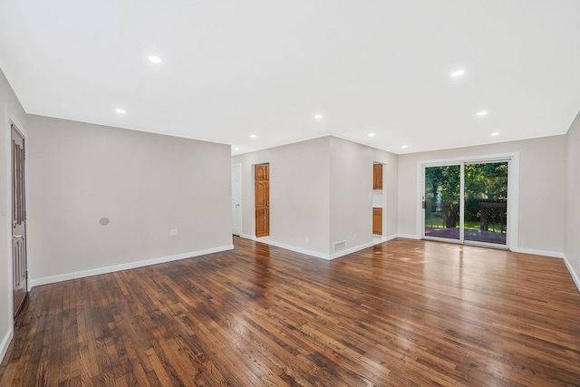 unfurnished living room featuring dark wood-type flooring