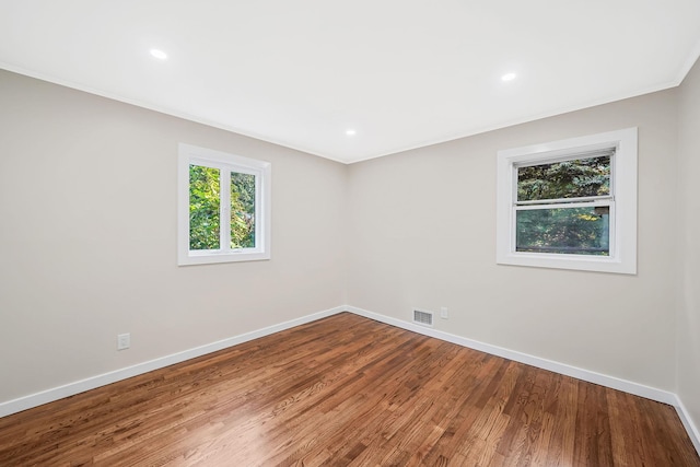 spare room with hardwood / wood-style flooring