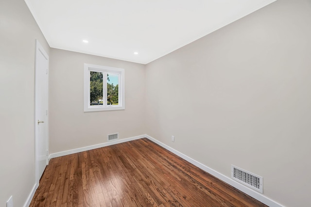 empty room with hardwood / wood-style flooring